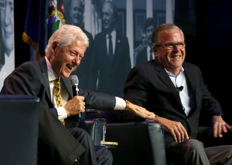 Former President Bill Clinton and former Florida Gov. Jeb Bush laugh during the George and Barbara Bush Distinguished Lecture Series at University of New England in Biddeford on Friday night.