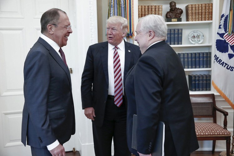 President Trump meets with Russian Foreign Minister Sergey Lavrov, left, and Russian Ambassador to the U.S. Sergei Kislyak at the White House in May 2017. Three former U.S. officials now say Trump told the senior Russian officials that he was unconcerned about Moscow's interference in the 2016 election.