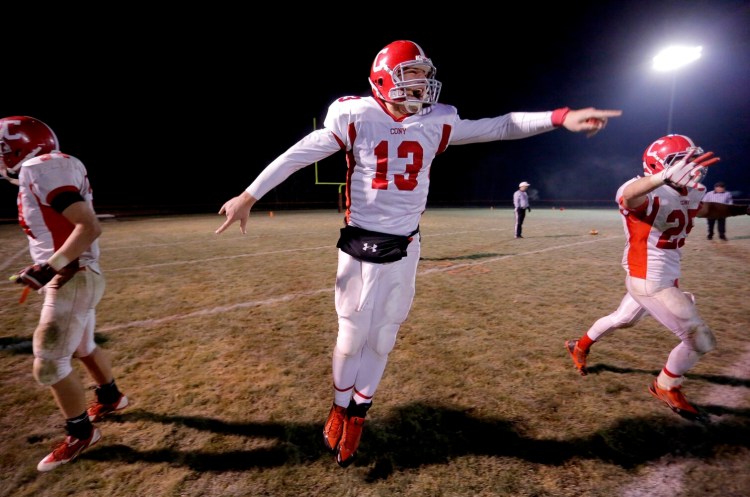 Cony quarterback Ben Lucas, center, leaps in celebration after the rams defeated Brunswick in a 2015 Eastern B playoff game.