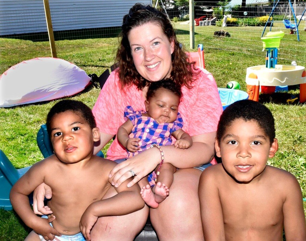 Mindy Saint Martin sits with her children Marcus, left, 2-month-old Mya and Donovan at their home in Waterville on July 9, 2018. Her husband, Lexius, has received a pardon for a drug trafficking charge from Maine Gov. Janet Mills that could lead to his returning to his family in the United States.