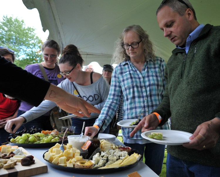 Ken and Pam Danforth, right of Hampden, Maine join others in sampling a cheese plate during a demonstration at 4th Annual Maine Cheese Festival in Pittsfield Maine Sunday September 8, 2019. The plate featured five different cheeses, dried and fresh fruits, nuts and a variety of crackers. 