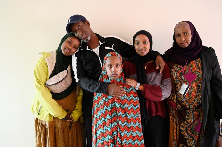 Abdigani Faisal Hussein poses at his home in Portland on Wednesday with his family, from left to right, Amira Hassan, 14, Faryaad Hassan, 15, Fahima Hassan, 16, and his wife, Hibo Abdi. 