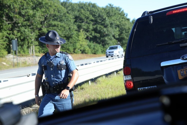 PORTLAND, ME - SEPTEMBER 5: Maine State Trooper Pat Flanagan returns to his unmarked cruiser after stropping a New York driver for speeding and viewing her cellphone while driving on Interstate 95 on Thursday. (Staff photo by Ben McCanna/Staff Photographer)