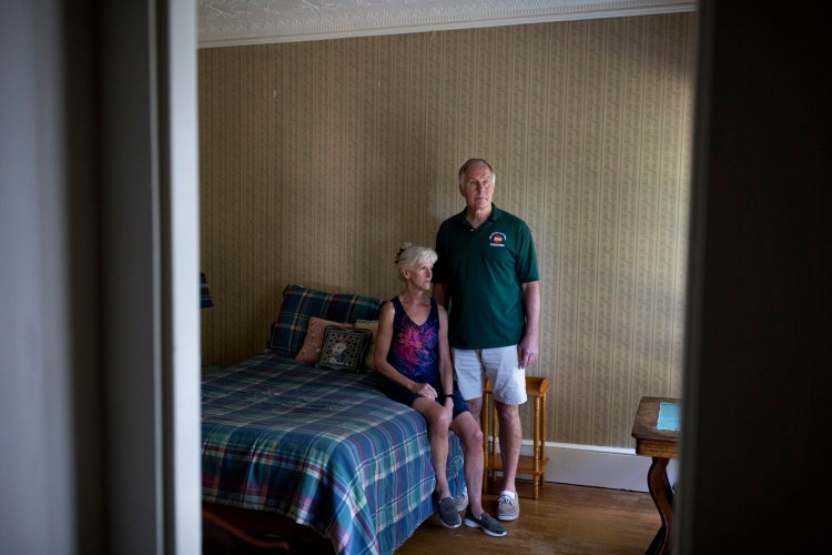 Sally McLaren and Ben Gumm sit in the now bare-bones bedroom of their son, Alex, at their home on Sept. 3.