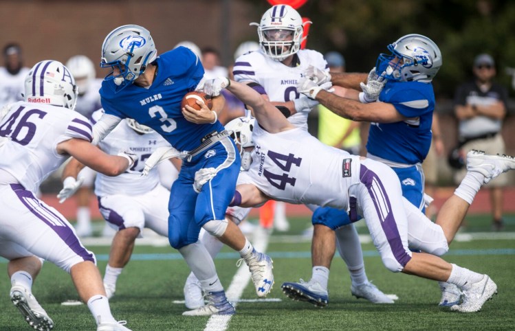 Colby College quarterback Matt Hersch scrambles for a short gain as he is tackled by Amherst's Joe Kelly on Saturday at Colby College in Waterville.