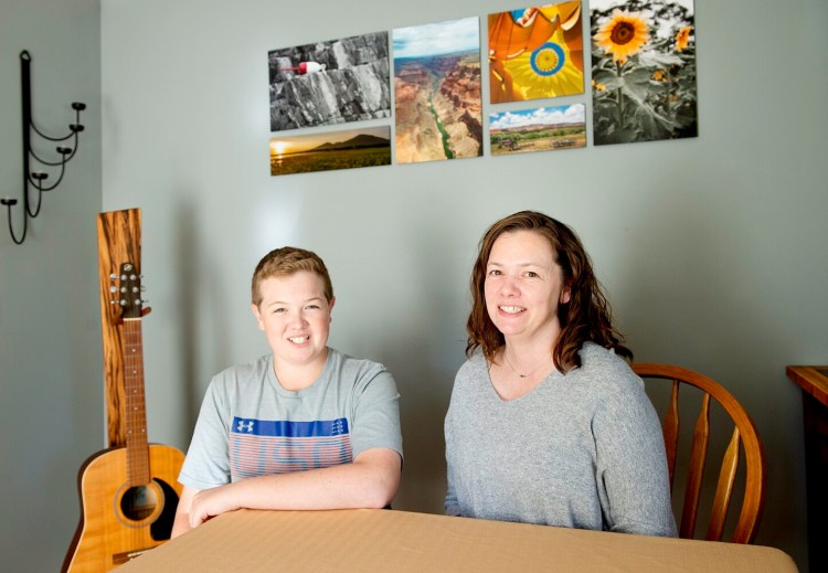 Amy Helie and her son Ethan, 15, will participate in their second Dempsey Challenge. Helie's husband and Ethan's father, Seth, died from cancer at 42. Seth Helie's photographs and wood designs decorate the Helie's home in Brunswick.