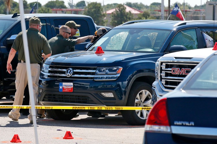 Officials continue working Monday at the scene in Odessa, Texas, where teenager Leilah Hernandez was fatally shot at a car dealership during Saturday's shooting rampage.