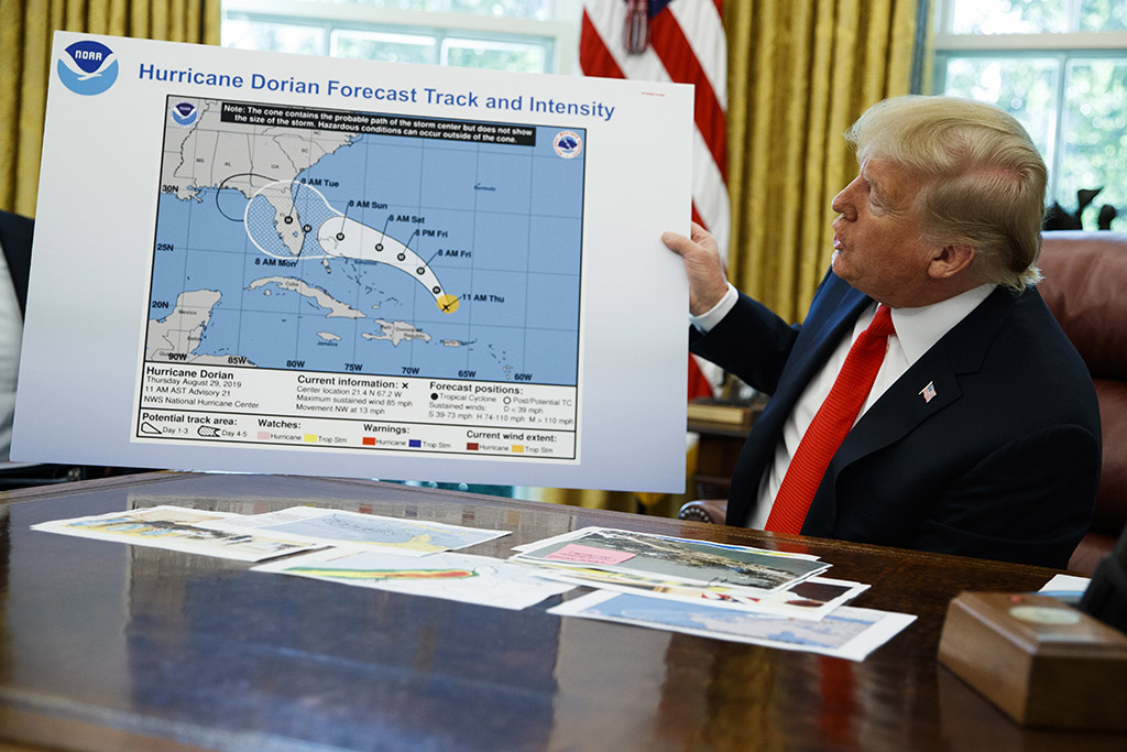 President Donald Trump holds a doctored chart of Hurricane Dorian's projected path.