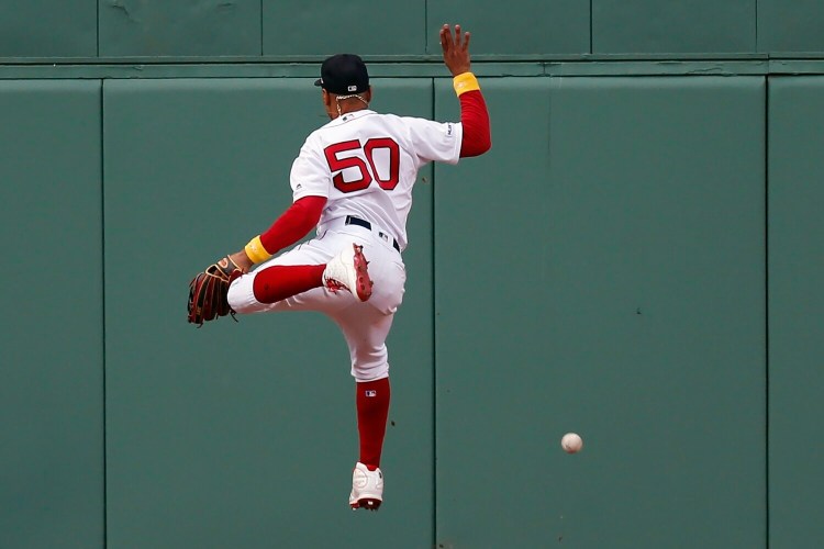Mookie Betts can not make the catch on a ball hit by New York's Luke Voit which resulted in a double in the eighth inning of the Yankees' 5-1 win on Saturday at Fenway Park.