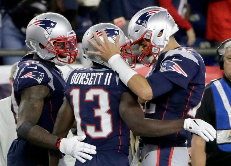 New England Patriots quarterback Tom Brady, right, celebrates after Brady threw a 10-yard touchdown pass to Dorsett in the second half against Pittsburgh on Sunday in Foxborough, Mass. Brady threw three touchdown passes and the Pats won 33-3.