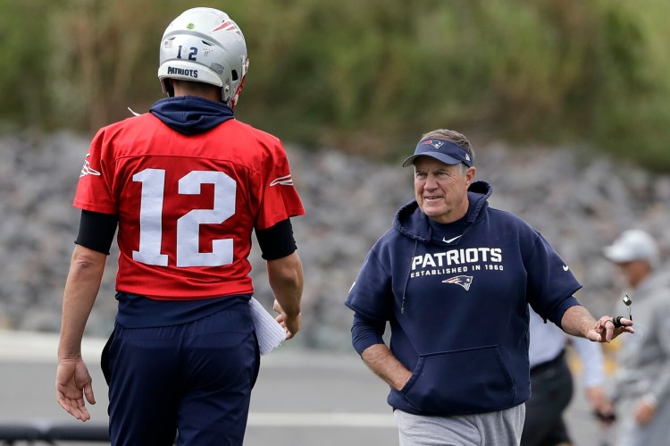 New England Patriots quarterback Tom Brady, left, and Coach Bill Belichick talk during practice, Wednesday
