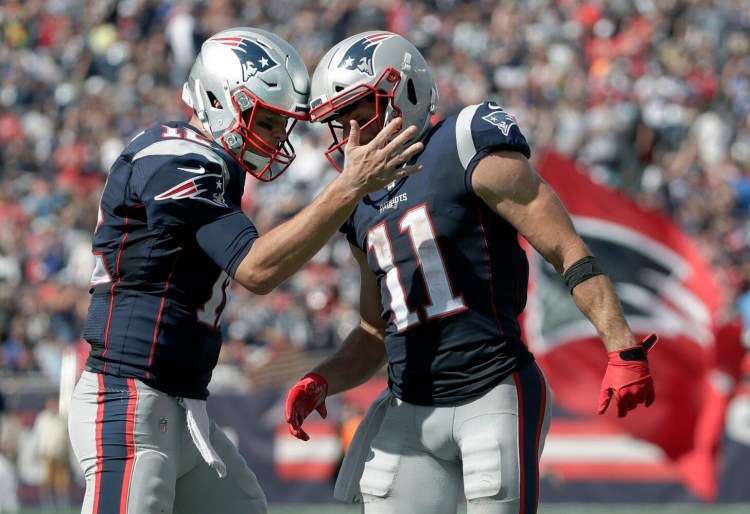 New England Patriots quarterback Tom Brady, left, celebrates with Julian Edelman after they hooked up for a touchdown pass in the Patriots' 30-14 win over the New York Jets on Sunday in Foxborough, Mass. 