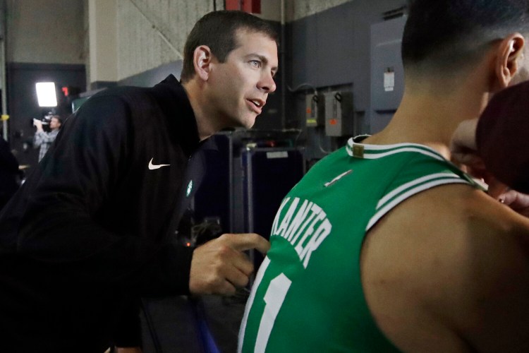 Boston Celtics Coach Brad Stevens leans in as Enes Kanter prepares to be filmed during media day on Monday in Canton, Mass.