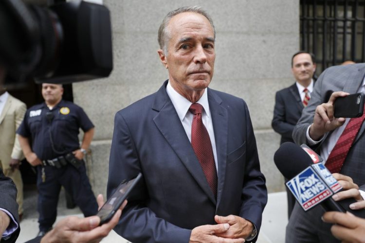 U.S. Rep. Chris Collins, R-N.Y., speaks to reporters as he leaves the courthouse after a pretrial hearing Sept. 12 in his insider-trading case in New York. Collins is resigning from his seat before an expected guilty plea in the case, in which he was accused of leaking confidential information during an urgent phone call made from a White House picnic. 