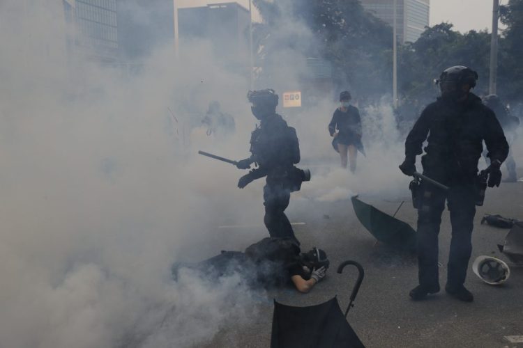 Riot police fired tear gas Sunday after a large crowd of protesters at a Hong Kong shopping district ignored warnings to disperse in a second straight day of clashes, sparking fears of more violence ahead of China's National Day.