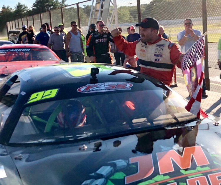 Pittston native Ben Ashline climbs out of his car and celebrates after winning the Boss Hogg 150 on Sunday at Wiscasset Speedway in Wiscasset.