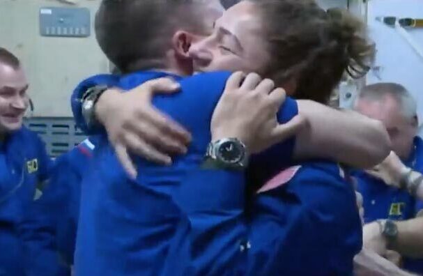 Maine astronaut Jessica Meir gets a big hug after arriving on board the International Space Station on Wednesday.