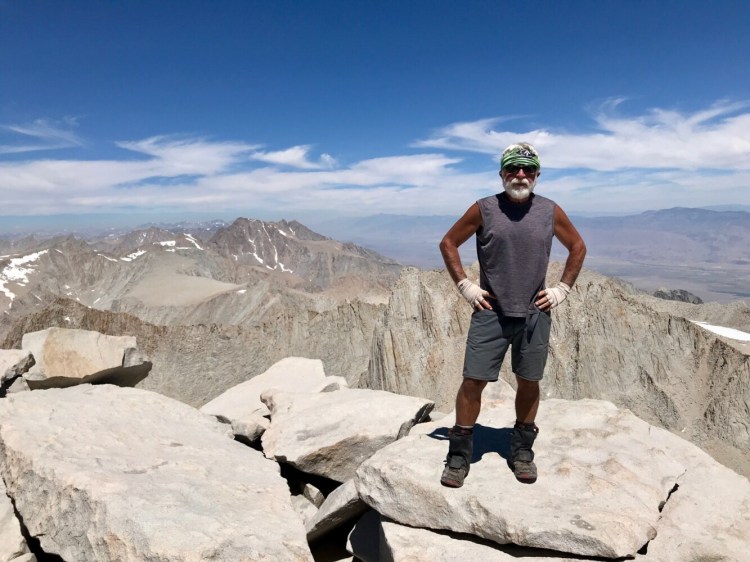 Carey Kish stands triumphantly atop 14,505-foot Mt. Whitney, the crown jewel of the High Sierra and the highest peak in the contiguous U.S. 
