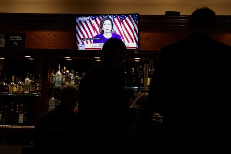 Journalists watch Speaker Nancy Pelosi announce a formal impeachment inquiry of President Trump, in the Trump Tower bar. 