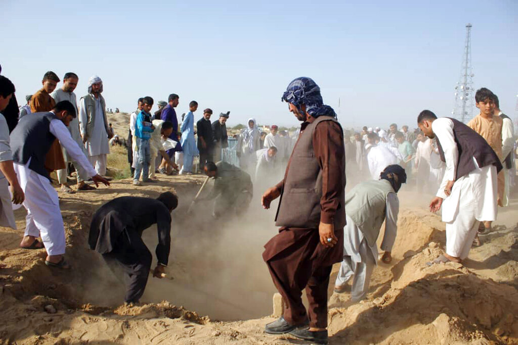 Afghan men bury security personnel killed in a suicide attack on Saturday in Kunduz province, north of Kabul on Sunday. The Taliban attacked a second Afghan city in as many days on Sunday and killed several members of security forces, officials said. 