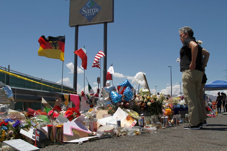Mourners visit the makeshift memorial near the Walmart in El Paso in August. Walmart wrote its own letter urging for a debate over reauthorizing an assault weapons ban.