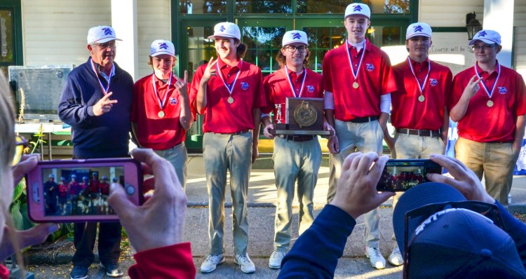 The Mt. Ararat golf team poses for photos after winning the Class A state title on Saturday in Vassalboro.