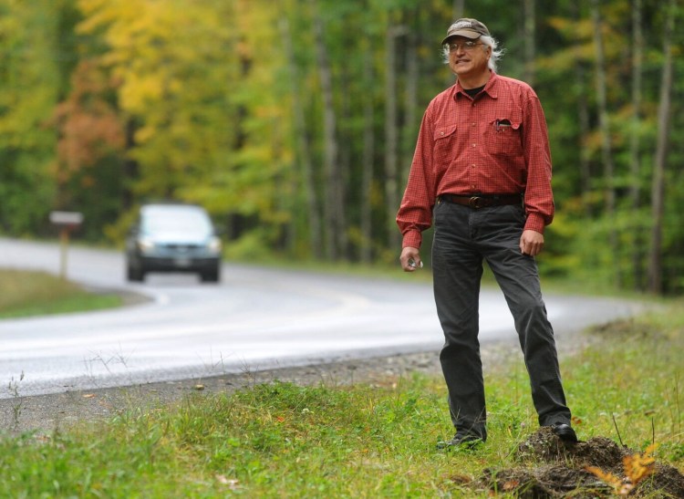 Tom Streznewski of Belgrade stands Oct. 2 near the section of Route 225 in Rome where his truck slid off the road in September and was destroyed.
