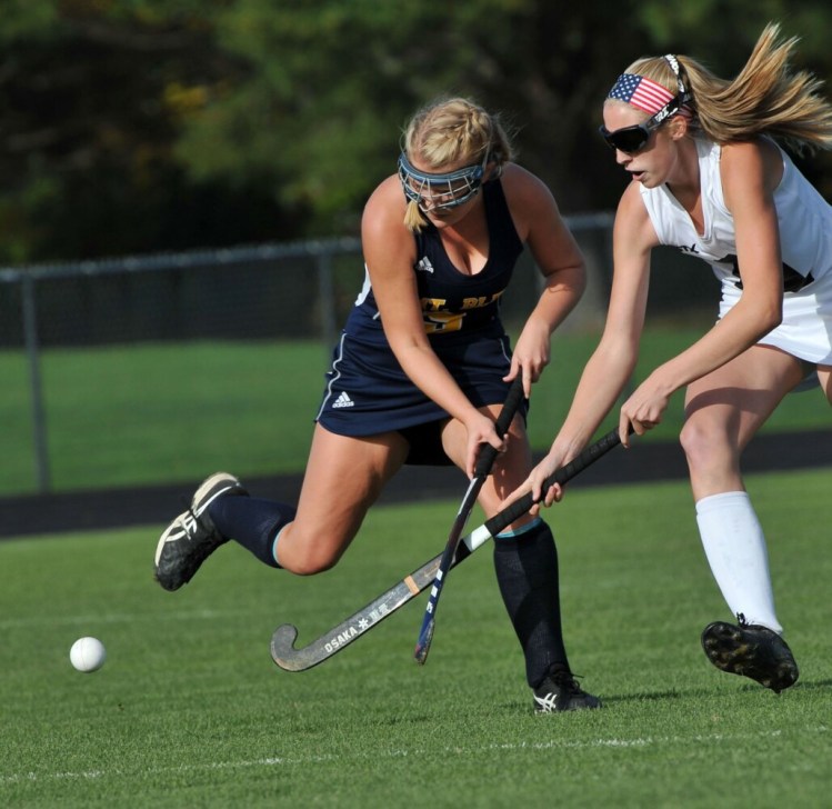 Skowhegan senior forward Emily Reichenbach, right, battles Mt. Blue's Bailey Levesque for possession of the ball during a Class A North field hockey game Tuesday in Skowhegan.