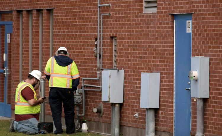 Natural gas technicians examine the service at the Maine State Police Crime Laboratory in Augusta on Thursday after a leak was reported at the building.