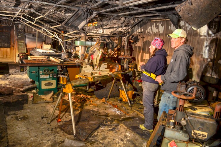 Amy Grant-Trefethen, left, and Brett Trefethen answer questions during a tour Thursday at the fire-damaged Barn Boards and More workshop in Mount Vernon.