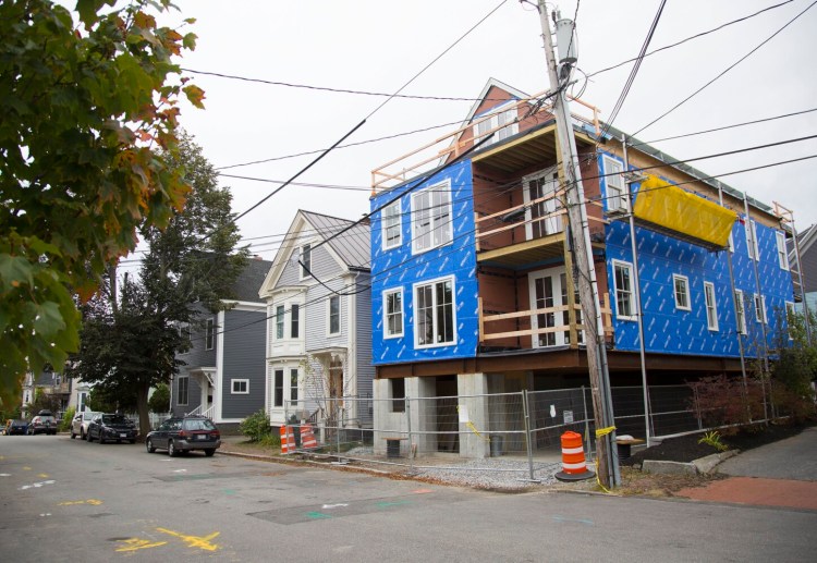 A multi-family home is under construction on O'Brion Street in Portland. The city has approved an abundance of new construction, but there are delays in finishing projects. And of those new homes on the market, many are unaffordable to a majority of city residents, according to a new report. 