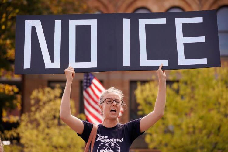 Emily Qualey of Portland holds a “No ICE” sign while chanting at a protest on Monday against an Immigration and Customs Enforcement office that will soon open at One City Center in Portland. 