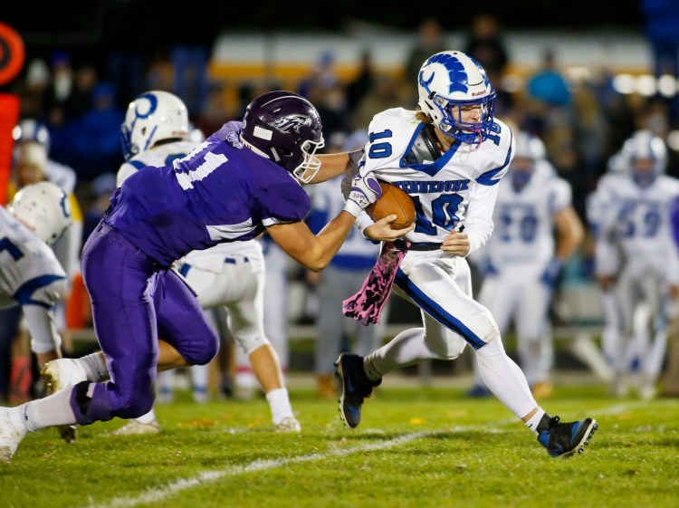 Connor Caverly of Marshwood grabs Tommy Lazos of Kennebunk during the Rams' 48-14 win Friday in South Berwick.