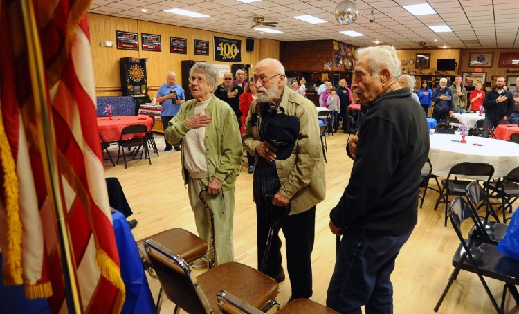 From left, WWII veterans Clara Gilbert, 96; Nunzio Biondello, 95, and Nicholas Ambulos, 91, join in reciting the Pledge of Allegiance at Tardiff Belanger American Legion Post 39 in Madison on Saturday. 