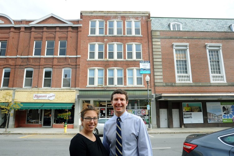 Tracy Nale, left, and brother Tom have purchased 99 Main St. in downtown Waterville. The property is pictured directly behind the pair on Tuesday. To the left of the couple are buildings they also own. At the right is The Center, the future home of the Paul J. Schupf Art Center.
