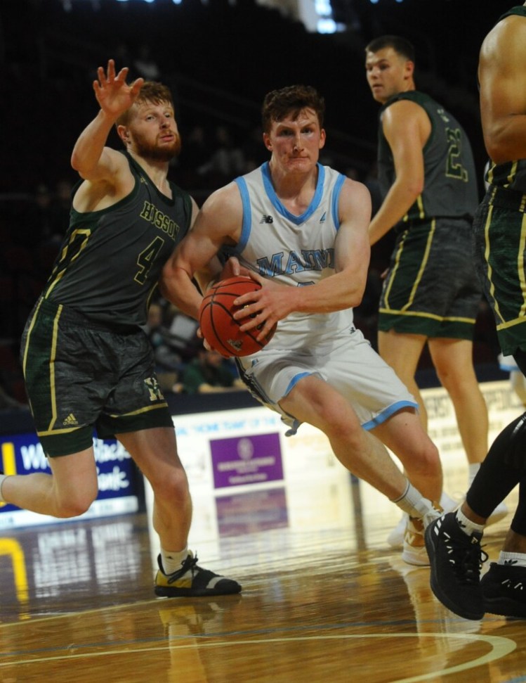 7107# 02menshoops BANGOR, MAINE - OCTOBER 27, 2019 University of Maine's Andrew Fleming takes the ball through Bruce St, Peter, left, in Bangor, Maine Sunday October 27, 2019, 2019. (Staff photo by Rich Abrahamson/Morning Sentinel)