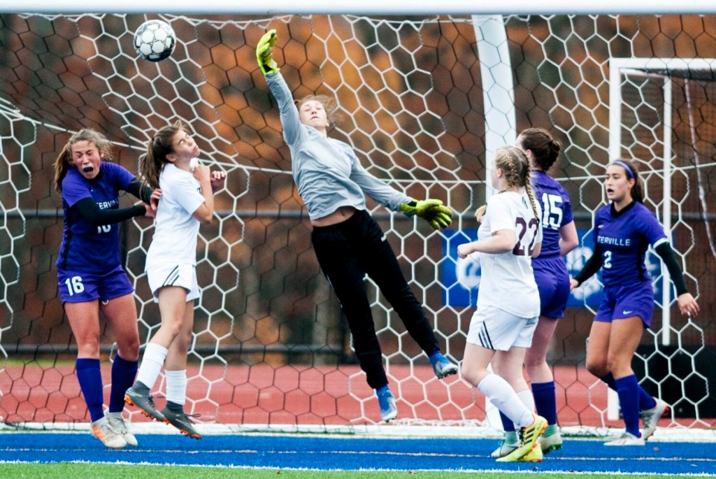 Waterville goalie Jacie Richard (35) makes a punch save on a corner kick as Maine Central Institute's Kayla French, second from left, tries to score on a header in front of Waterville defenders Jayda Murray (16) and Lindsay Given (15) during a Class B North quarterfinal game last week at Messalonskee High School in Oakland.