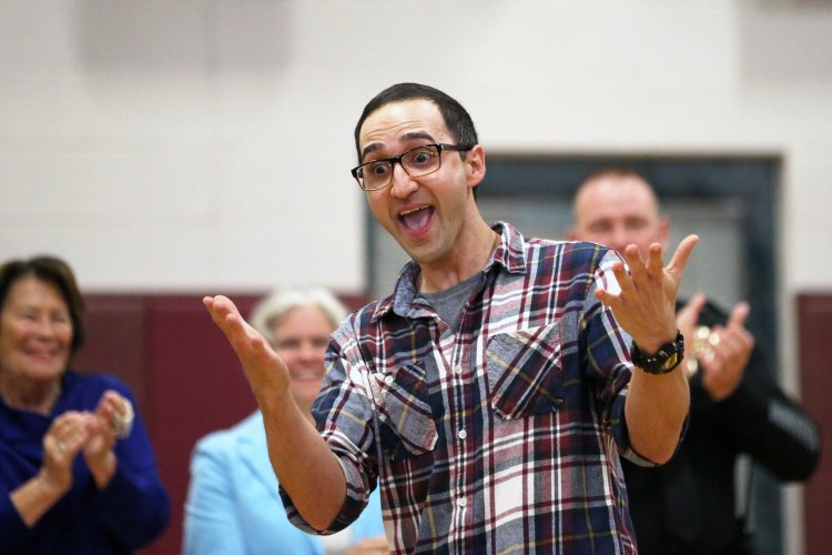 Gorham High School teacher Adam Parvanta reacts to winning a Milken Educator Award during a surprise assembly at the school Wednesday morning. The awards, known as "the Oscars of teaching," recognize excellence annually with $25,000 awards to 40 teachers across the country. 