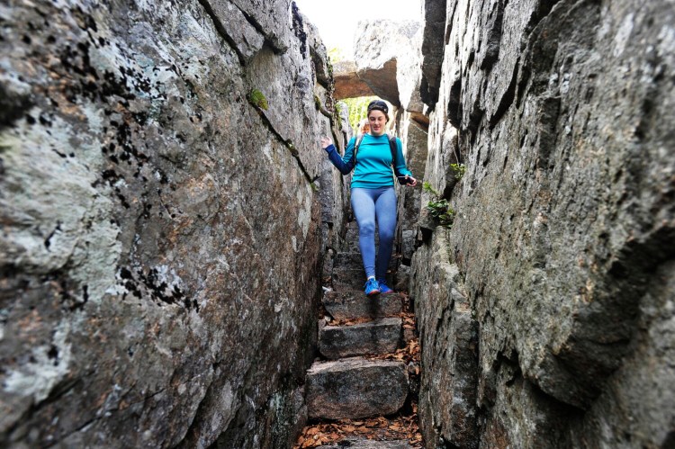 Lynette Gumbleton of Kalamazoo, Michigan, leads the way down the stairs on Homans Path in Acadia National Park in 2017. The path, along with the park's entire trail system, could be listed on the National Register of Historic Places.