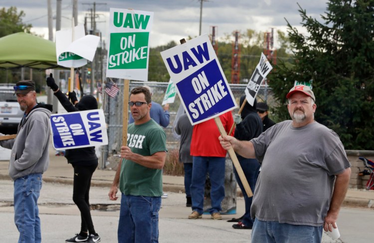 John Kirk, right, a 20-year-employee, pickets with co-workers Oct. 4 outside the General Motors Fabrication Division in Parma, Ohio. The strike ended Oct. 25 after the union agreed to a new contract with GM.