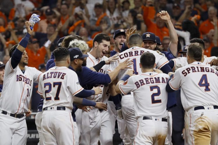 Houston's Carlos Correa celebrates with teammates after his walk-off home run against the New York Yankees during the 11th inning. 