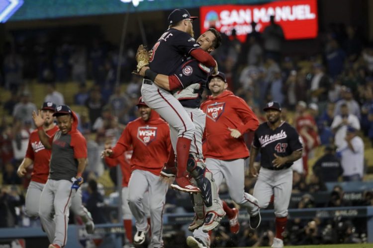 Washington Nationals pitcher Sean Doolittle, left, and catcher Yan Gomes leap in celebration after the team's 7-3 win in Game 5 of a baseball National League Division Series against the Los Angeles Dodgers on Wednesday.