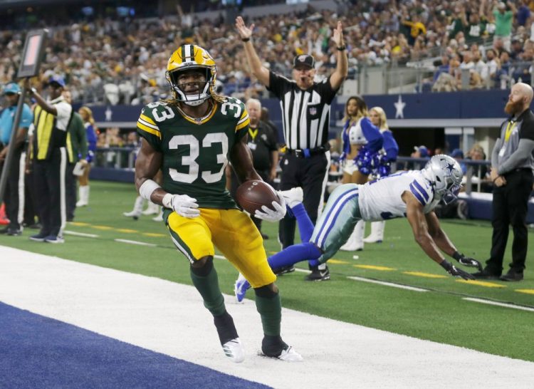 Green Bay’s Aaron Jones celebrates on of his four touchdowns during the Packers’ 34-24 win over the Dallas Cowboys on Sunday in Arlington, Texas. 