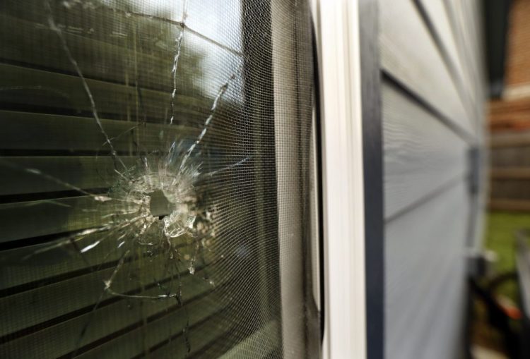 A bullet hole from the Fort Worth, Texas, police officer's shot is seen in the rear window of Atatiana Jefferson's home Tuesday. Jefferson, a black woman, was shot by a white police officer early Saturday. 