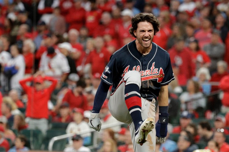 Atlanta Braves' Dansby Swanson celebrates after scoring during the ninth inning of the Braves' 3-1 win over the Cardinals in Game 3 of the NLDS on Sunday in St. Louis.