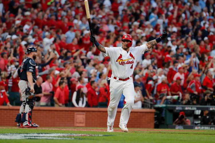 Yadier Molina celebrates after hitting a sacrifice fly to give the Cardinals a 5-4 win over the Atlanta Braves in Game 4 of the NLDS on Monday in St. Louis. Game 5 is Wednesday in Atlanta.