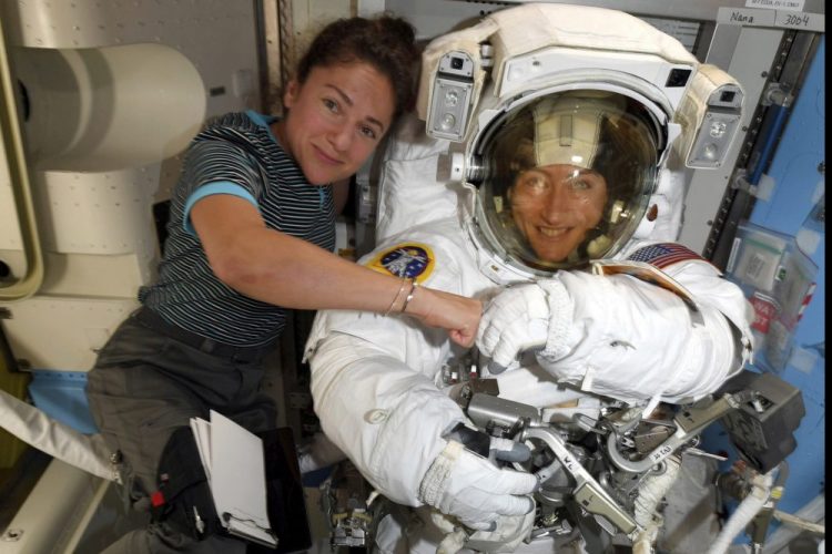 Astronauts Christina Koch, right, and, Jessica Meir pose for a photo on the International Space Station. NASA has moved up the first all-female spacewalk to Thursday or Friday because of a power system failure at the International Space Station. 