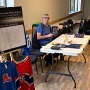 Allan Globensky, former hockey player and Kennebec Ice Arena manager, signs copies of his book, "A Little Knock Won't Hurt Ya!" 