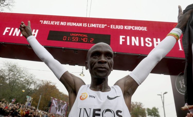 Marathon runner Eliud Kipchoge from Kenya celebrates under the clock after crossing the finish line of the INEOS 1:59 Challenge after 1:59:40 in Vienna on  Saturday. He is the first human ever to run a marathon under two hours.