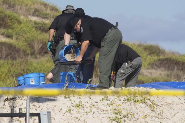 Several state agencies conduct an investigation on a Padre Island, Texas, beach in Kleberg County after two bodies were found there, on Monday. 